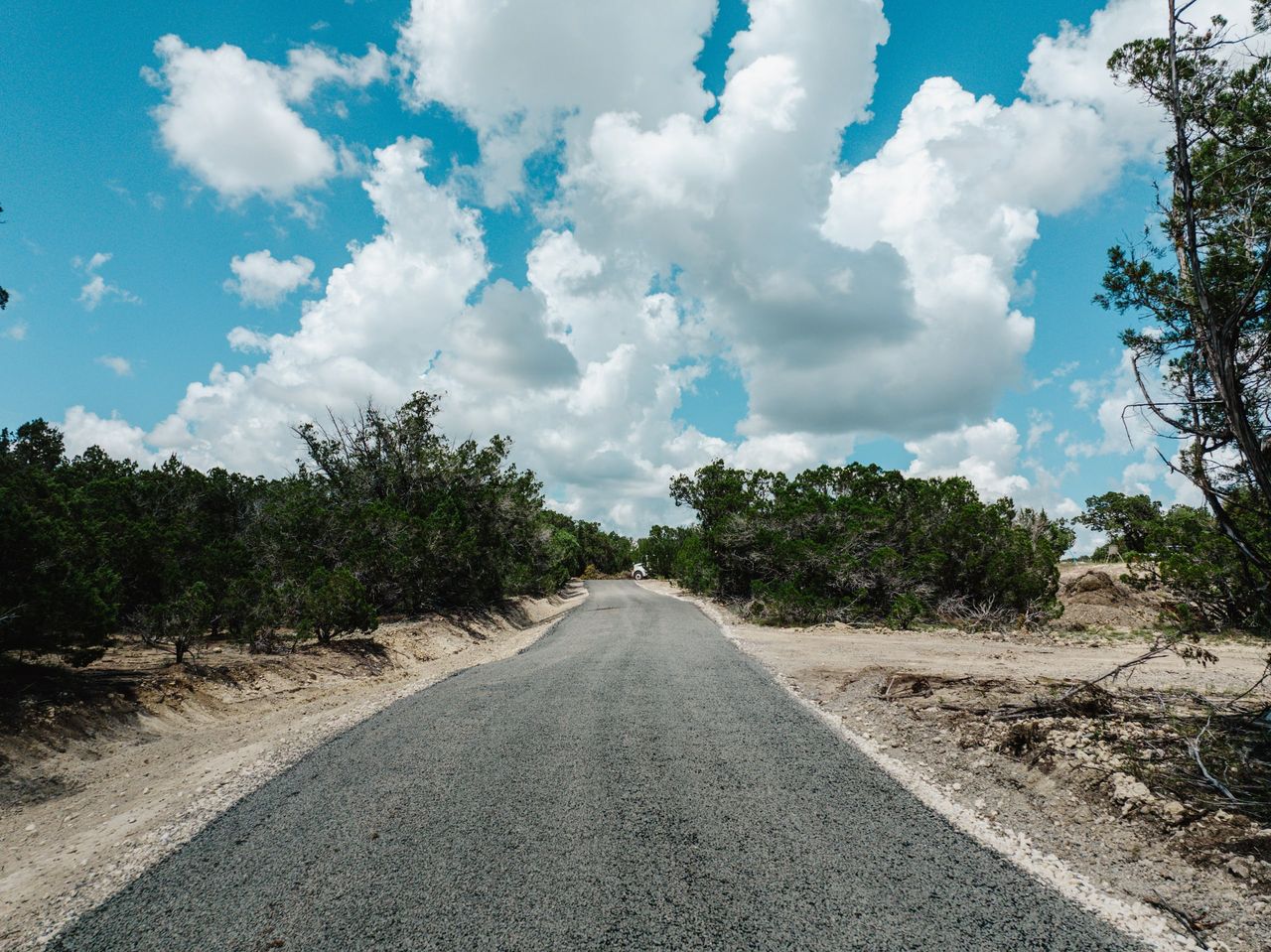 Aerial view of a finished rural road through rocky terrain