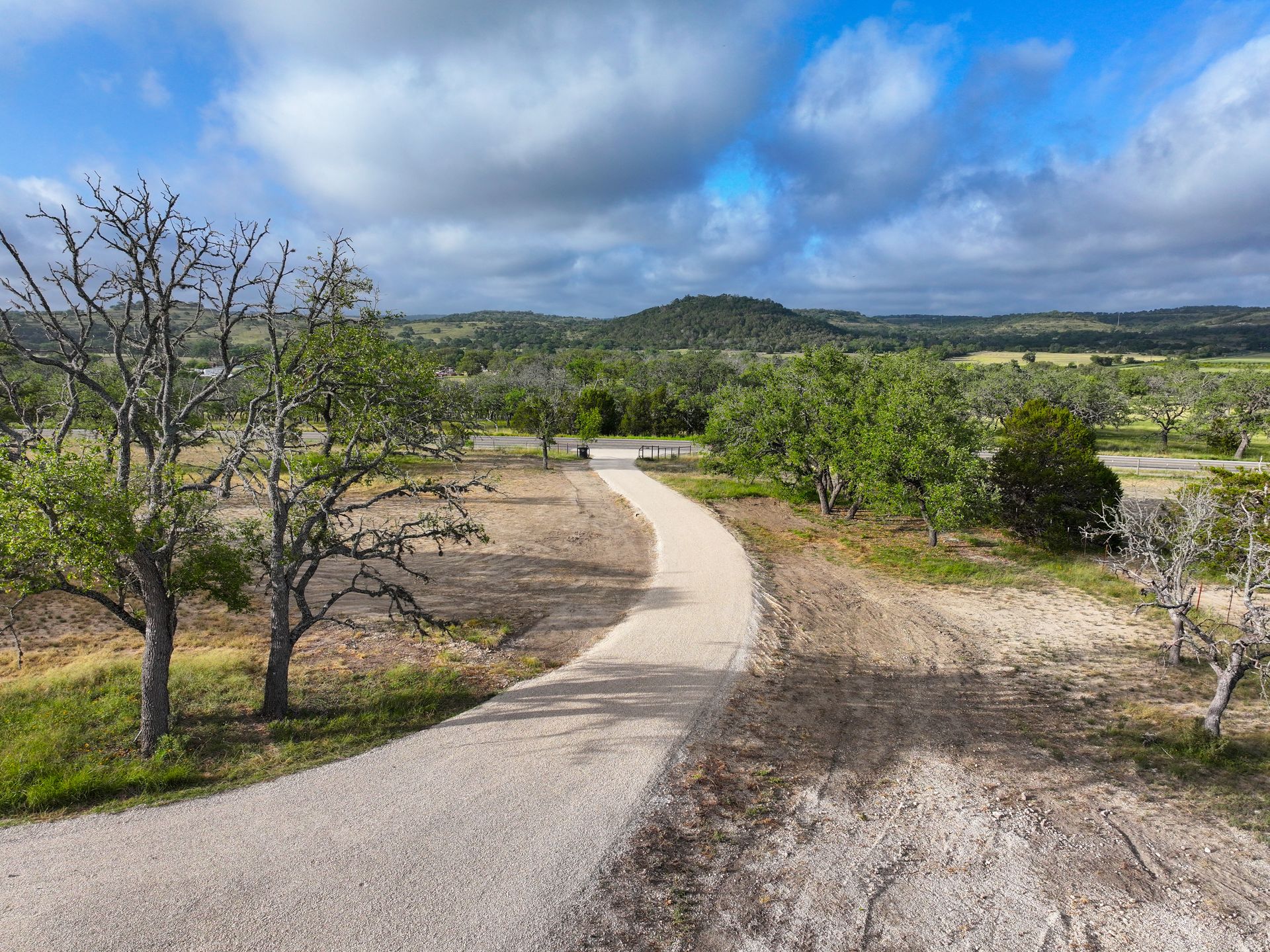 Finished curving rural drive with a textured paved surface