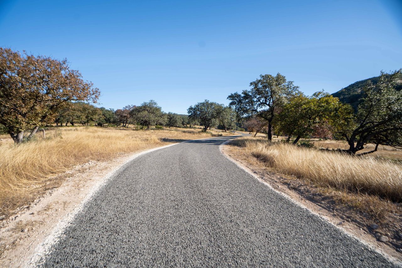 Finished rural road curving through open land