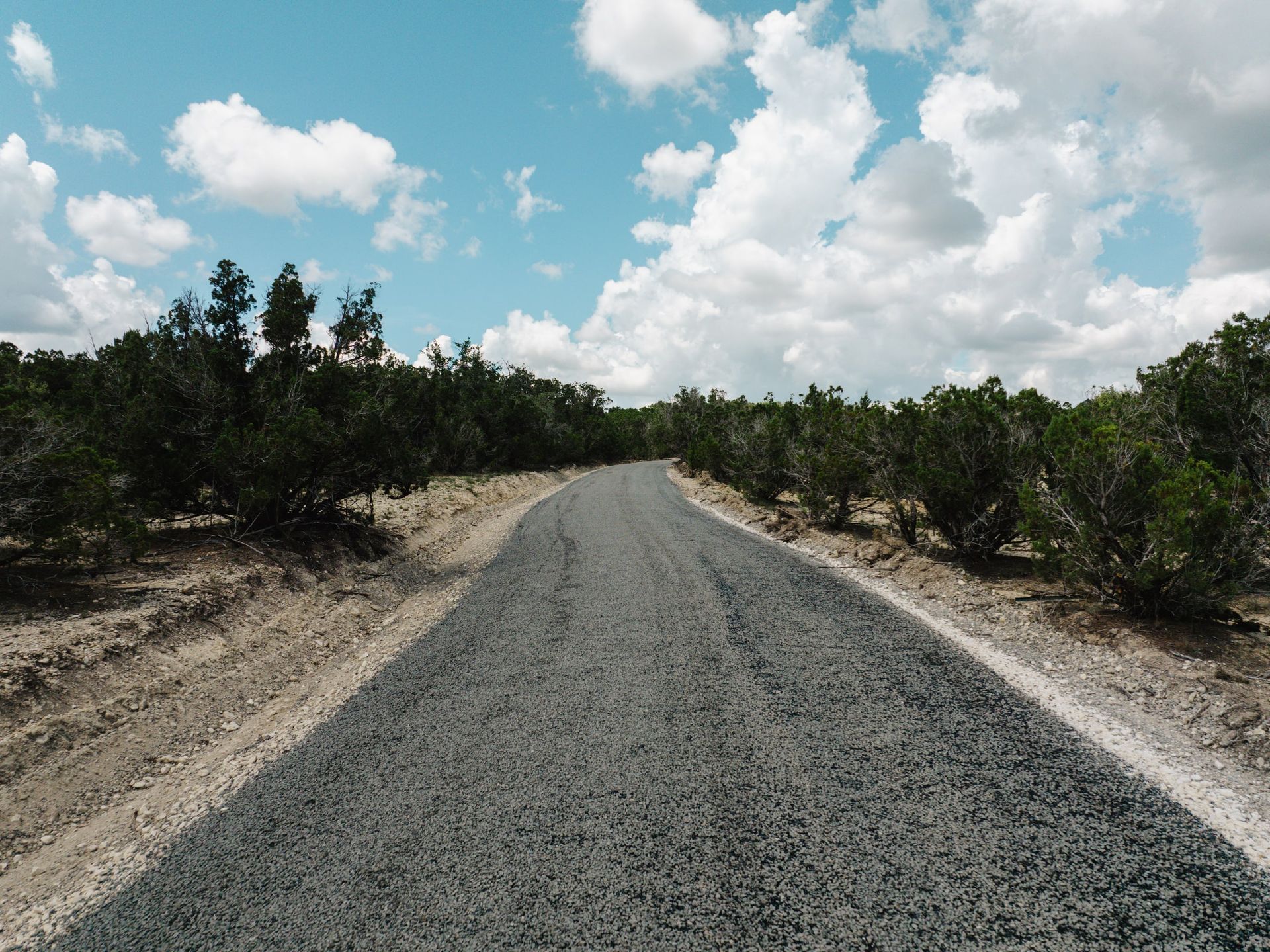 Finished aggregate-surface road crossing rocky terrain