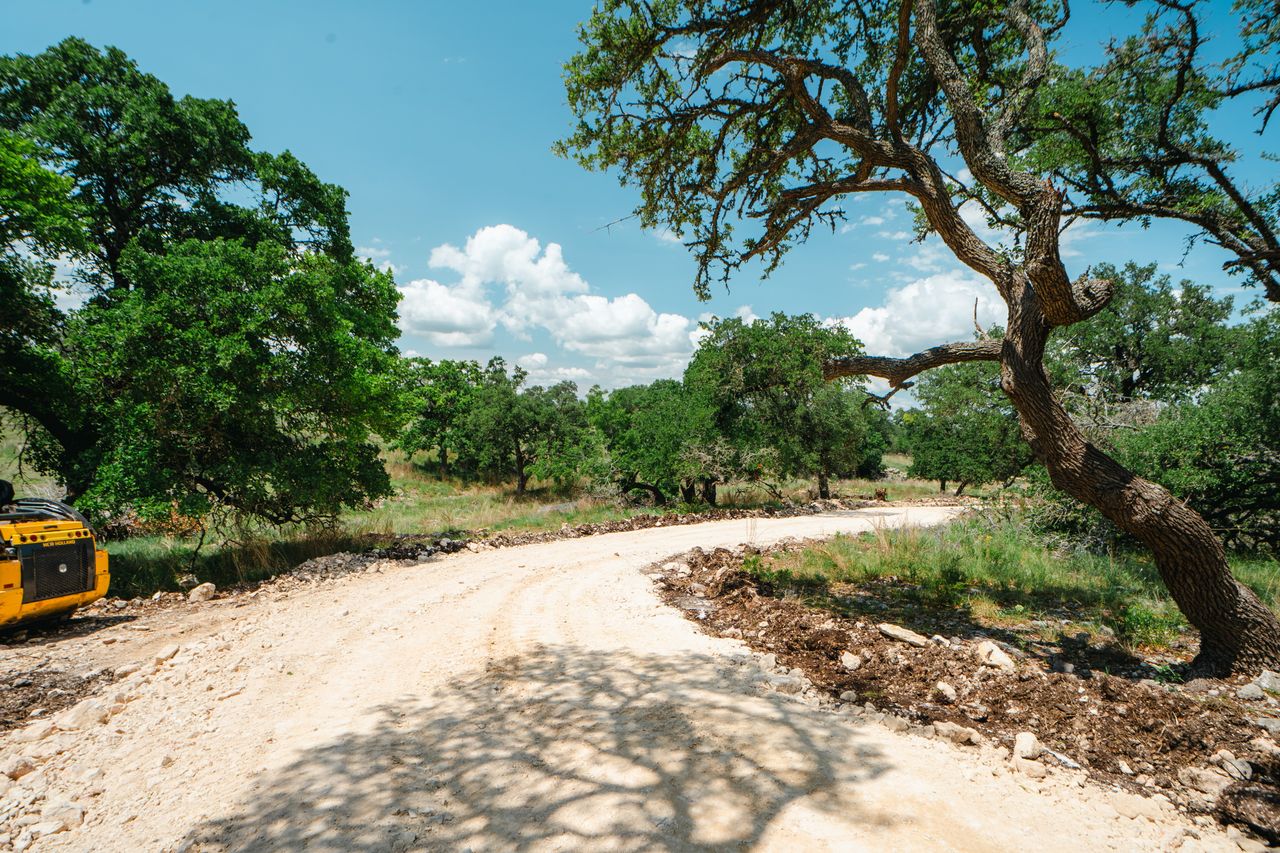 Rural road extending across open Texas property