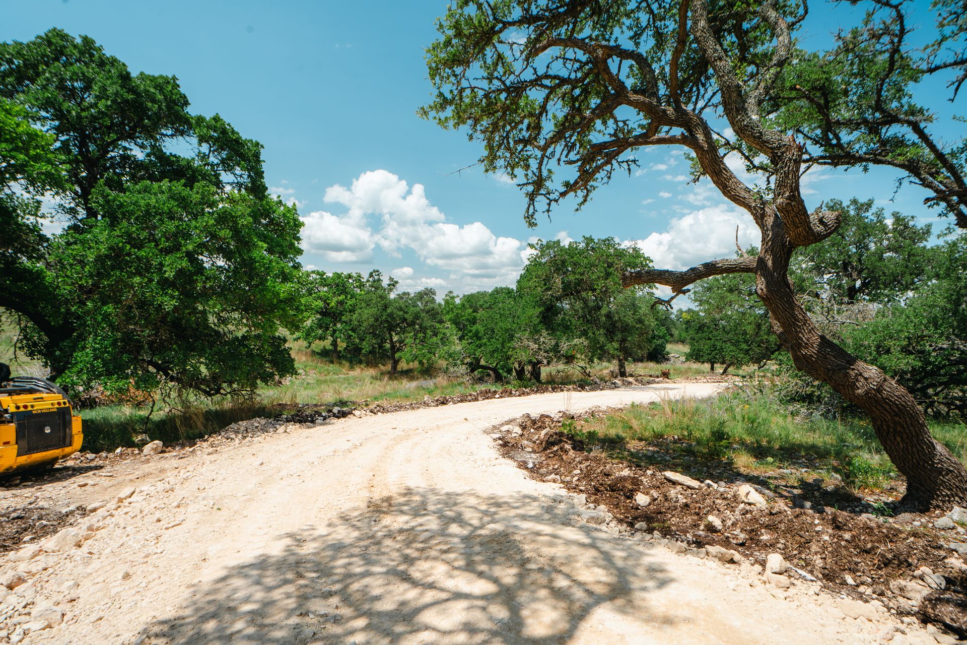 Rural road extending across open Texas property