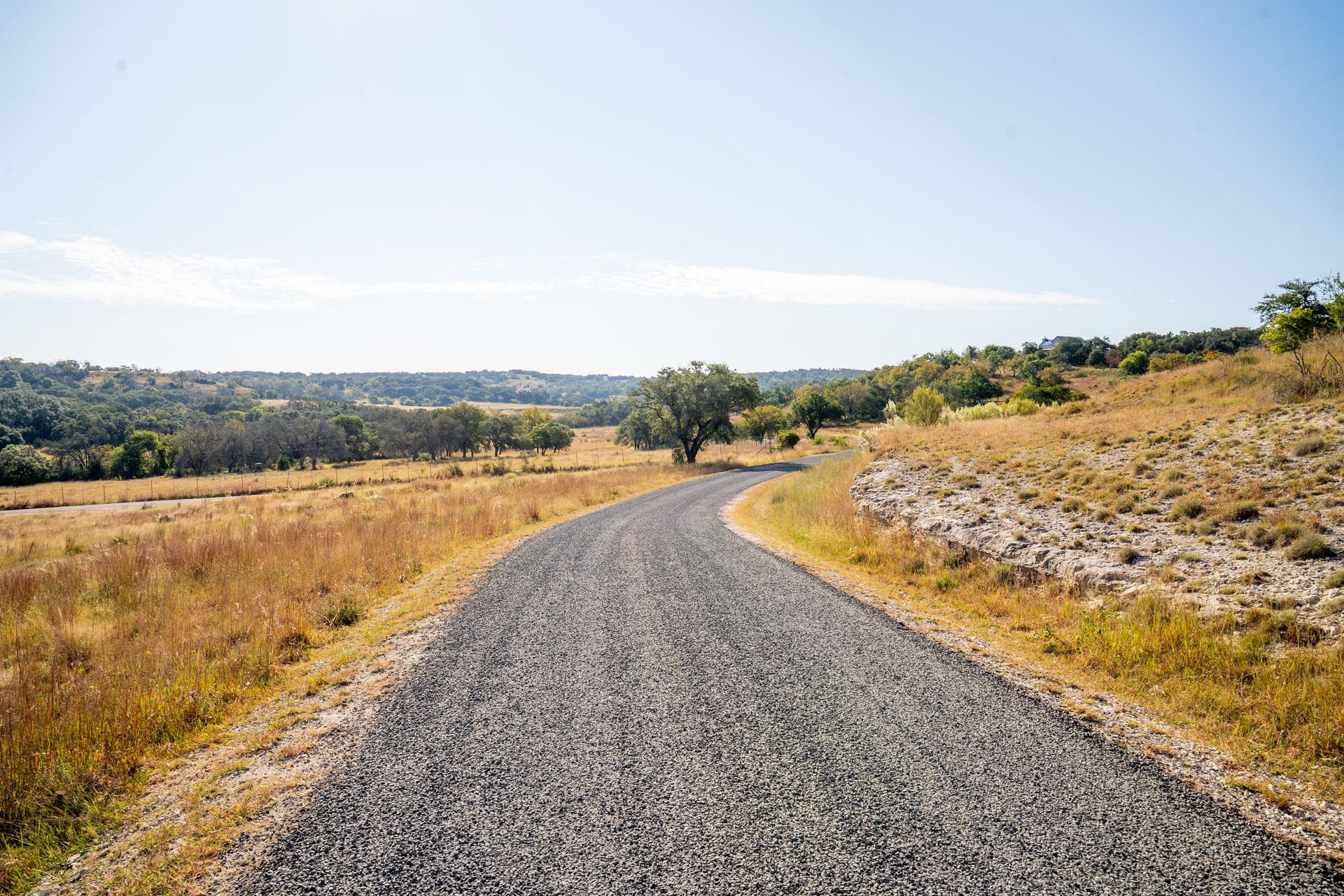 Finished aggregate-surface road curving through open country