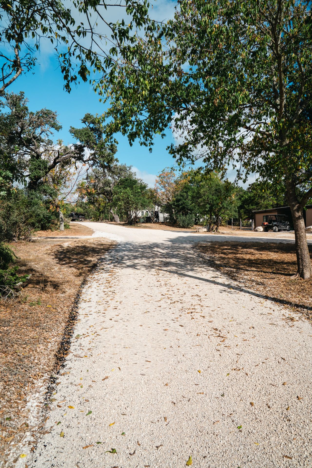 Prepared aggregate surface leading toward a rural home