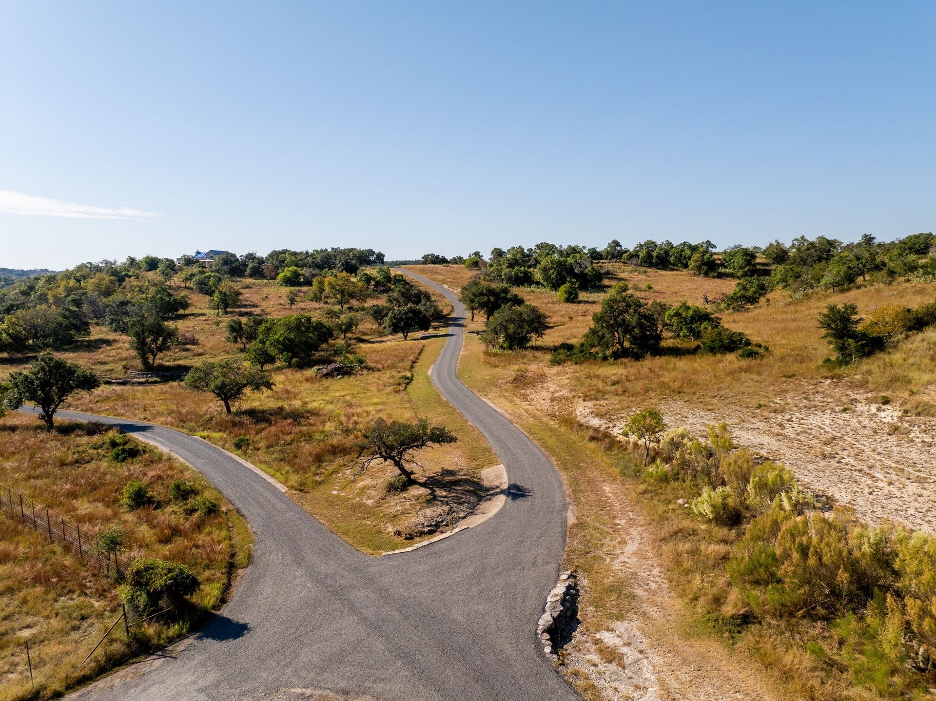 Aerial view of a private road system across a wooded property