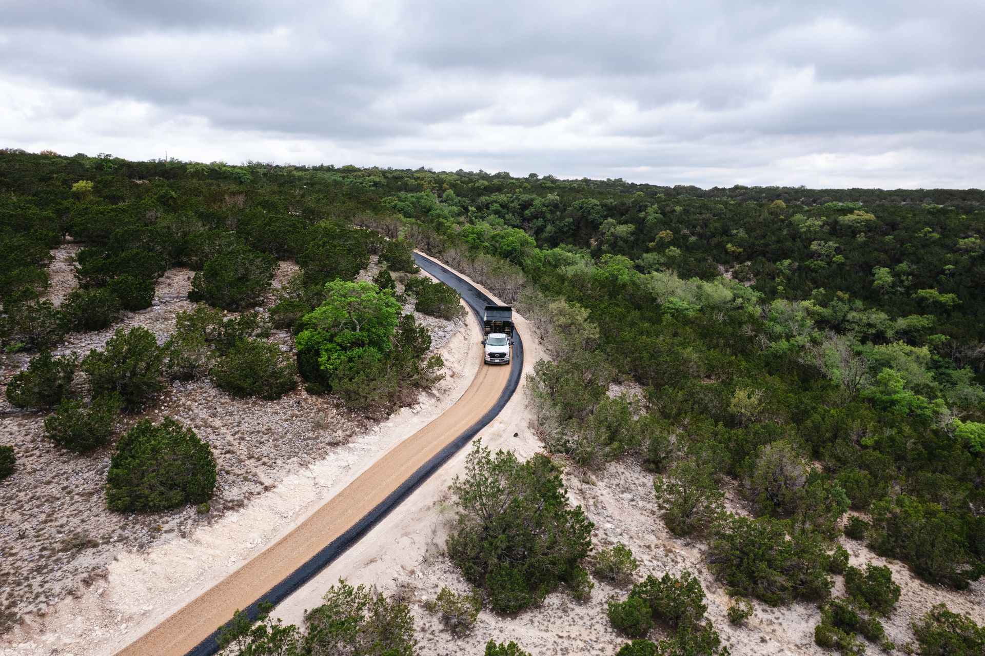 Aerial view of a long rural road during active road work