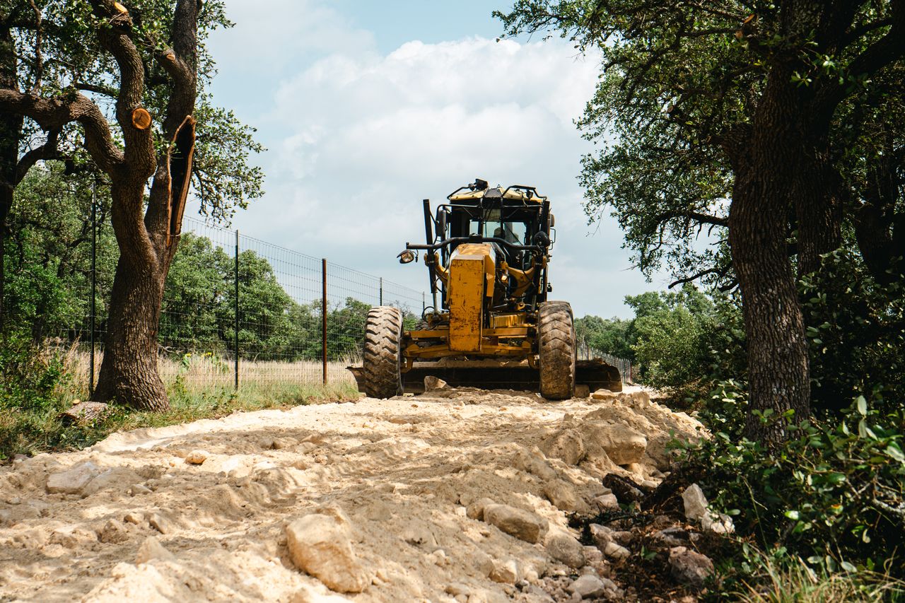 Grading equipment shaping a rural road surface