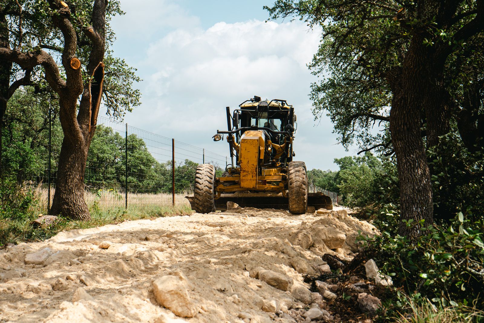 Motor grader shaping an existing rural road