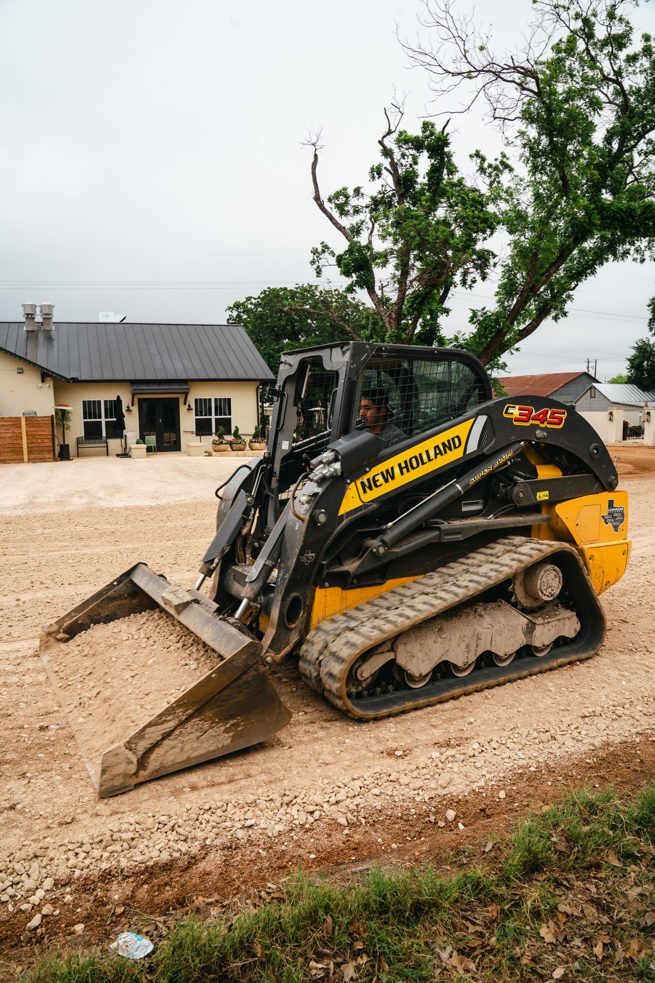 Skid-steer preparing an aggregate road base