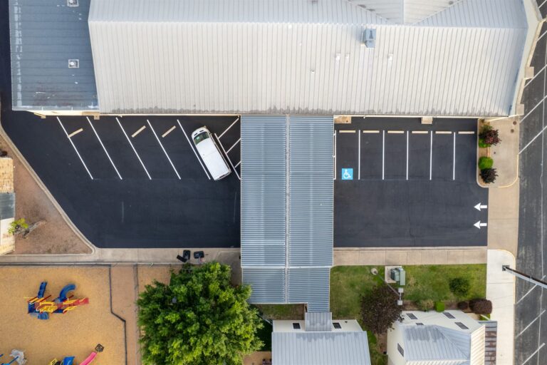 Aerial view of a freshly paved and striped parking lot by Rafferty Paving