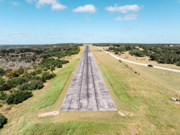 Aerial view of a worn private airstrip before resurfacing