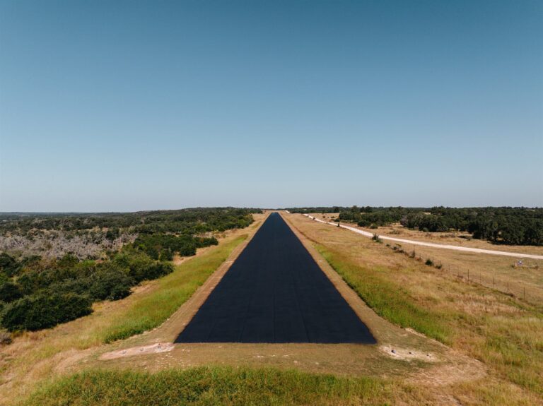 Aerial view of a newly paved private airstrip in the Texas Hill Country