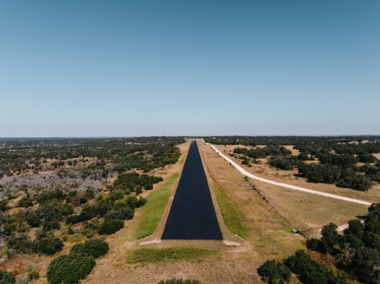 Aerial view of a newly paved private airstrip in the Texas Hill Country