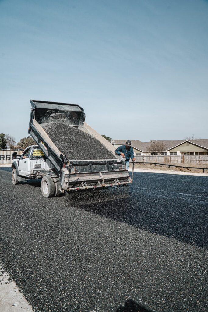 Dump truck unloading aggregate on a Rafferty Paving job