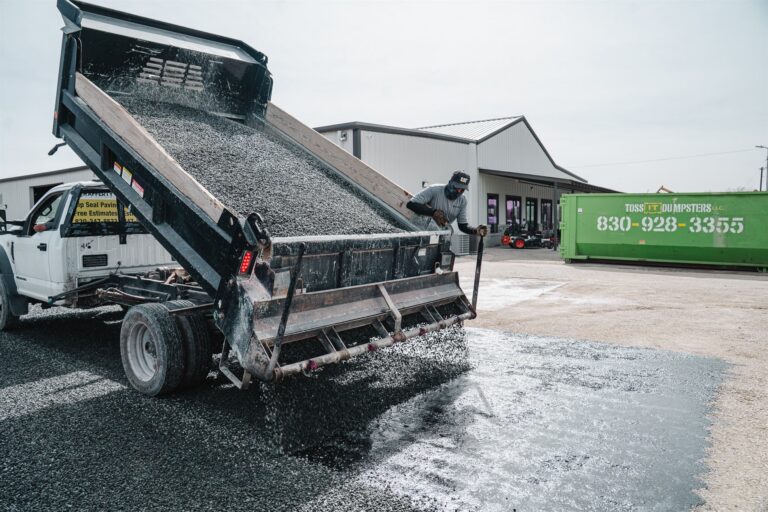 Dump truck unloading aggregate on a Rafferty Paving job
