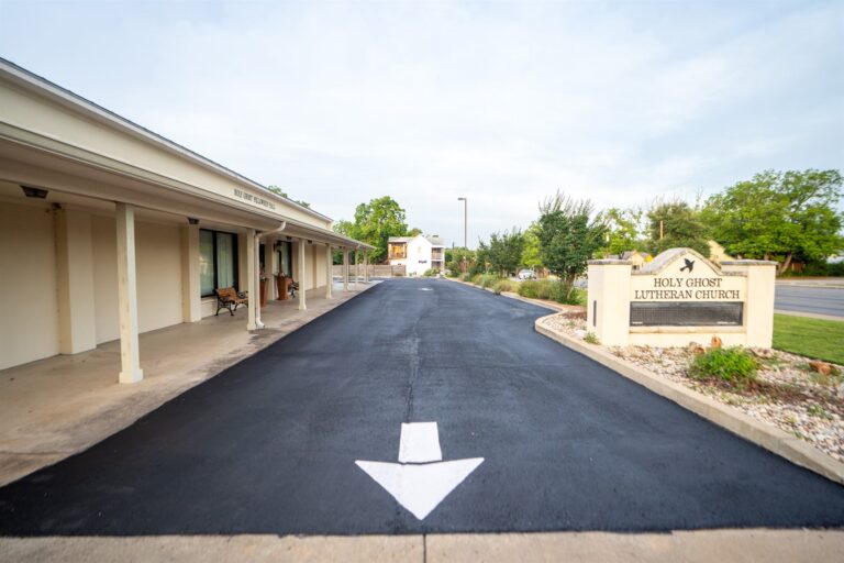 Freshly paved and sealed church parking lot with new striping