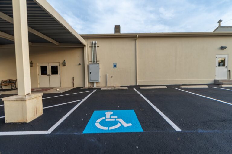 Freshly paved and sealed church parking lot with new striping