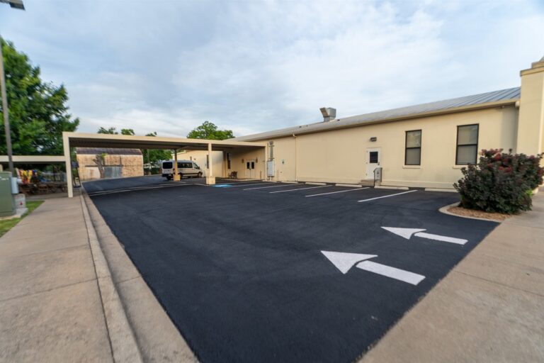 Freshly paved and sealed church parking lot with new striping